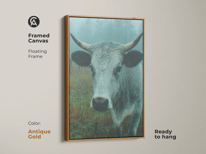 Framed canvas artwork depicting a cow in a misty field. The antique gold floating frame enhances this ready-to-hang piece. A sophisticated art choice for your home.
