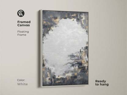 Framed canvas art showcases charcoal grey and gold abstract artwork with a white floating frame. This ready-to-hang piece adds a modern touch to any room. The contemporary artwork enhances a living room or office. Its neutral palette with metallic accents is versatile.