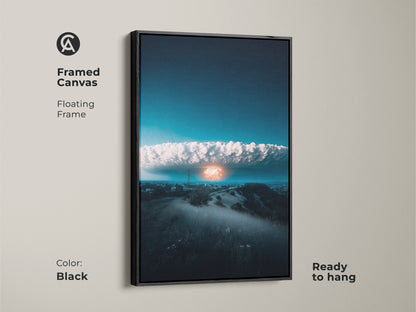 Framed canvas art displaying a surreal nuclear explosion over a cityscape. The floating frame is in black and the art is ready to hang. Deep blue and orange tones make it ideal for modern office or home decor. This conceptual artwork adds a thought-provoking touch.