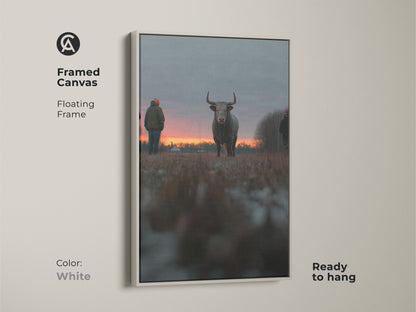 Framed canvas artwork of a bull at sunset with a floating white frame. This ready-to-hang piece is ideal for farmhouse wall decor. The rustic animal art enhances any bedroom. This orange red gray art is a perfect gift for farm lovers. The white frame adds a modern touch