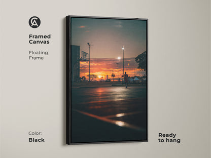 Framed canvas art of a sunset basketball court. The floating frame adds depth to this stunning piece. Ready to hang. A great addition to any modern art collection. Black frame.