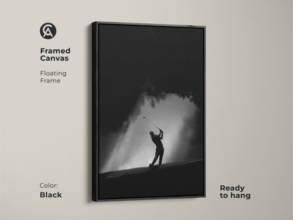 Framed canvas featuring a golfer. The black floating frame adds a touch of elegance. The artwork is ready to hang. The black and white tones create a sophisticated look. A great addition to any room.