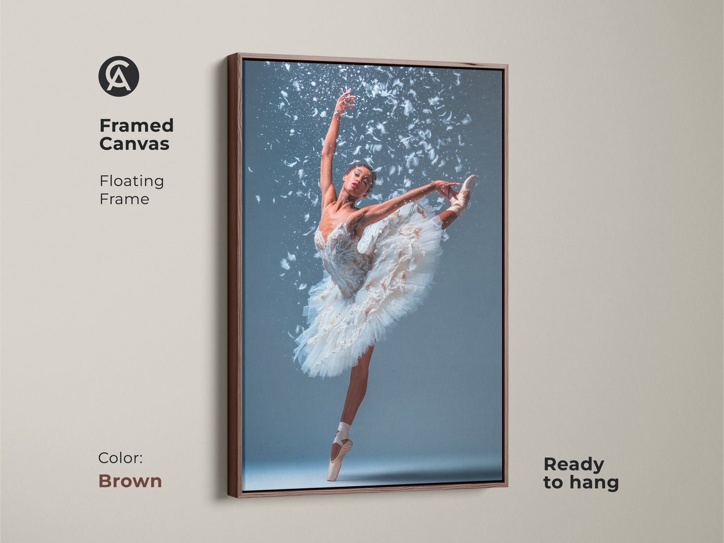 Framed canvas art featuring a ballerina. She is wearing a white tutu. She is en pointe with one leg extended. White feathers accent the artwork. The floating frame is brown. This beautiful ballet art is ready to hang.