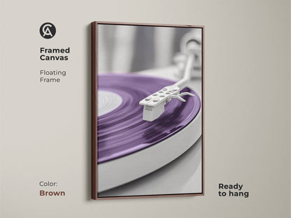 Brown framed canvas print featuring a purple vinyl record. This abstract turntable artwork offers a minimalist mid-century modern aesthetic. Ideal for a music room or home office wall. A great gift for music lovers and record collectors. The floating frame enhances the modern art.