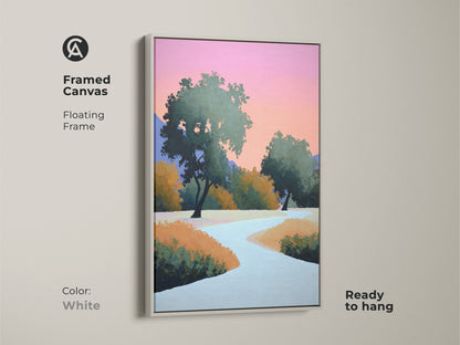 White framed canvas showcasing a modern abstract landscape. Contemporary trees wall art with a floating frame is displayed. The pink and orange sky artwork compliments the modern nature scene. Ready to hang stylized nature painting.