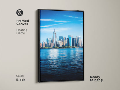 Framed canvas of the New York City skyline. This photorealistic New York art print features a floating frame in black. Ready to hang this blue cityscape wall art enhances any office. The iconic building wall art is a modern decor piece.