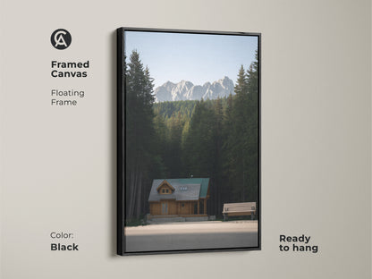 Framed Canvas art of a log cabin. This mountain forest canvas print features a floating frame in black. It is ready to hang. The rustic home decor art brings an outdoor adventure to your wall.