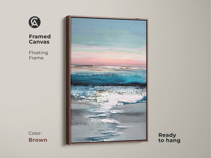 Framed canvas with brown floating frame displaying abstract coastal art. This ready-to-hang teal blue and pink artwork enhances living spaces. The contemporary textured ocean sky print adds a modern touch. An ideal piece for serene coastal home decor.