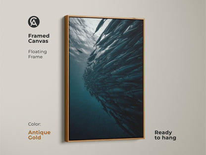 Framed canvas featuring a school of fish with an antique gold floating frame. This underwater ocean wildlife print is ready to hang. The contemporary fish artwork offers a cinematic underwater scene. A deep blue gray teal wall art for modern homes.