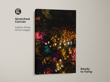 Stretched canvas featuring colorful floral artwork. The art features a dark background with vibrant flowers in pink orange and white. Gallery wrapped canvas art with mirror edges. Ready to hang this floral artwork in your home today.