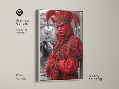 Unique Venetian Jester in a crimson costume is on a framed canvas. The white floating frame enhances the theatrical artwork. This red masquerade print is perfect for adding an eclectic accent to any room. It's ready to hang.