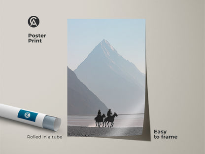 Poster print featuring cowboys on horseback in a misty blue mountain landscape. Minimalist western art for easy framing. Rolled in a tube for safe delivery. Modern scenic artwork brings a touch of the open range to your home. Perfect outdoor lover gift.