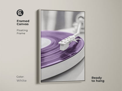 White framed canvas print of a purple vinyl record. This abstract turntable artwork offers a minimalist mid-century modern style. Ideal for a music room or studio apartment. This is a perfect gift for music lovers and record collectors. Ready to hang.