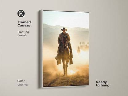 Framed canvas artwork featuring a Western cowboy on horseback. The floating frame is white and ready to hang. A cowboy rides in a dusty tan landscape. This canvas art makes a great gift for horse enthusiasts.