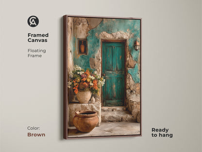 Framed canvas in brown showcasing a Mediterranean villa print. A rustic flower art featuring a charming teal door. This travel lovers gift print brings bohemian interior art to your walls. The botanical scene canvas adds rustic elegance to any room.