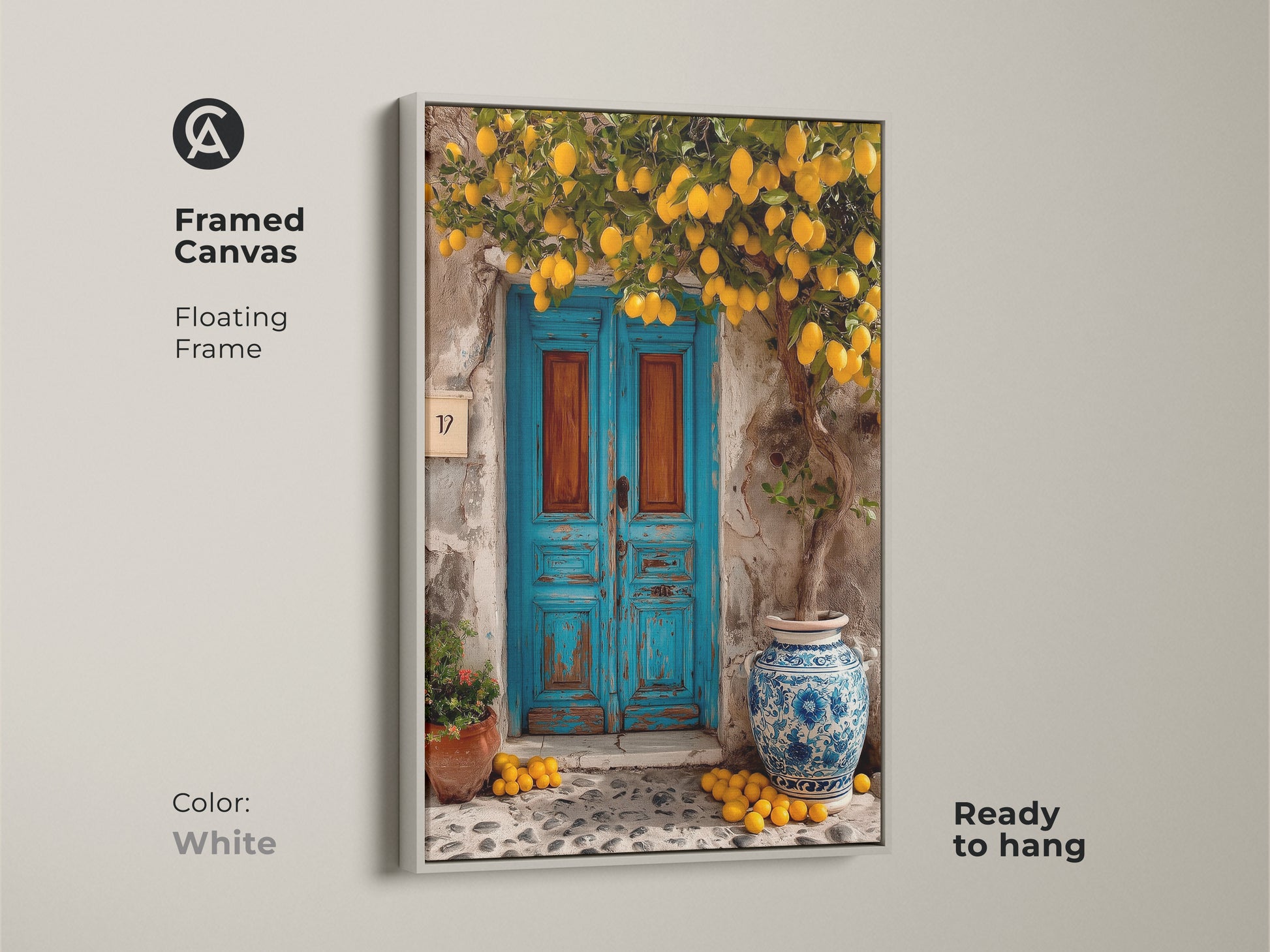 Framed canvas artwork of a Mediterranean lemon tree and blue door with a white floating frame. The ready-to-hang print adds a rustic touch to your home. This boho kitchen art brings sunny travel vibes to any space. Perfect as a housewarming gift.