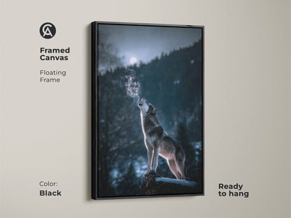 Framed canvas of a wolf howling at the moon in a blue gray forest. This floating frame is black. The rustic forest wall art is ready to hang. This wildlife print adds an atmospheric touch to any space. It is ideal for nature and animal lovers.