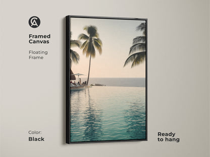 This framed canvas features an infinity pool with palm trees. A floating frame in black makes it ready to hang. Enjoy a coastal ocean view with this tropical beach landscape artwork.
