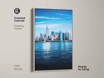 Framed canvas of the NYC skyline art with a floating white frame. Ready to hang modern art complements a modern home. It is a bright blue city art.