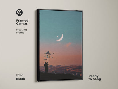 Framed canvas of surreal space artwork. Floating frame in black. This dreamy moon canvas art is ready to hang. Features a celestial landscape wall art. Perfect for modern bedroom decor. The fantasy tree silhouette print enhances any room.