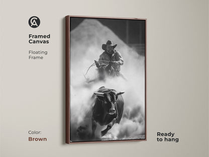 Framed Canvas of a Monochrome Rodeo scene in a brown floating frame. This Western wall art features a bull rider and charging bull. The rustic cowboy decor is ready to hang. Perfect for a man cave or office. This adrenaline art print captures the spirit of the rodeo.