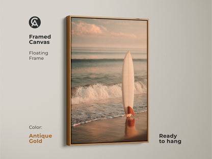 Antique gold framed canvas art featuring a surfboard on the beach. The floating frame enhances the artwork. It is ready to hang. This piece brings a touch of coastal charm to your home. Perfect for ocean lovers.