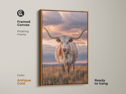 Framed Texas Longhorn canvas art with an antique gold floating frame. Ready to hang this country western decor enhances your space. This savanna sunset landscape adds a rustic touch. A photorealistic animal print is perfect for animal lovers.
