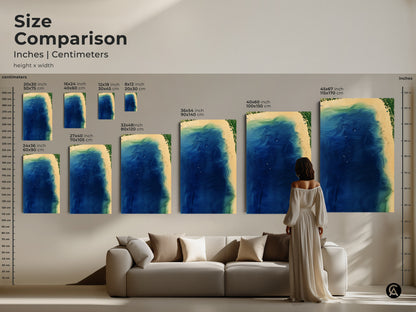 Size comparison of abstract coastal art prints in inches and centimeters. Various sizes are displayed above a sofa. The artwork features deep blue ocean waves and aqua green coastal details. Find the perfect size for your space today