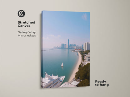 A stretched canvas art print showing a coastal cityscape with a yacht and sailboat. This gallery-wrapped artwork has mirror edges and is ready to hang. The ocean view art print features modern aqua blue artwork. It is a contemporary cityscape print perfect for travel lovers. The coastal scene offers nautical themed wall decor.