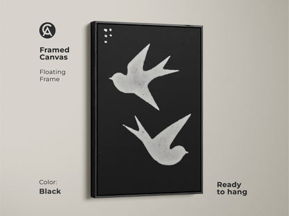 Framed canvas featuring minimalist bird artwork. The black and white art print has a floating frame. Ready to hang Scandinavian decor for any room. Abstract swallows add a touch of modern folk art. Perfect neutral color art.