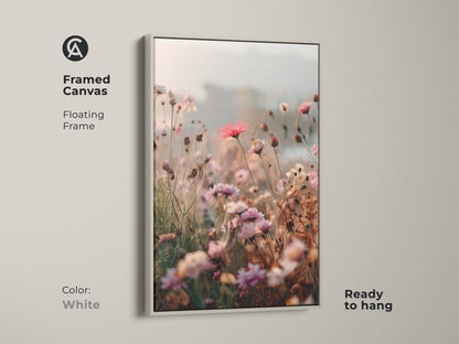 Framed Canvas in white with a floating frame showcasing Soft Focus Floral Art Print. This coral pink daisy and cosmos botanical wall art adds boho blush pink to any room. Ready to hang and makes a great housewarming gift.