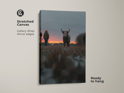 Stretched canvas print of a bull at sunset. The gallery wrap showcases mirror edges. Ready to hang this artwork brings farmhouse charm to your walls. Ideal rustic animal art for bedroom wall hanging. The orange red gray art complements any country home decor