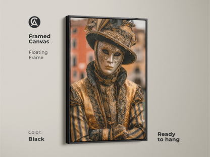 Black framed canvas Venice Carnival Mask artwork. The artwork features a person wearing a traditional gold mask and costume. It adds an elegant touch to any room. This framed canvas is ready to hang.