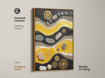 Antique gold framed canvas of a yellow and black abstract. The textured canvas art is ready to hang. It features pebble and gear details. This mixed media art enhances modern spaces.