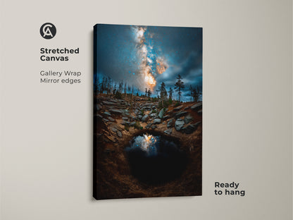 Stretched canvas art shows a serene mountain pool under the Milky Way. Gallery wrap with mirror edges makes it ready to hang. A cosmic landscape print adding celestial charm to your space.