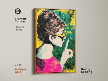 Framed canvas of Audrey Hepburn pop art with a antique gold floating frame. The artwork showcases a retro halftone style in pink yellow and teal. It is ready to hang. Ideal eclectic home decor.