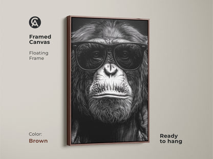 A framed canvas displays a chimpanzee in sunglasses. This black and white gorilla art has a brown floating frame. It is a primate portrait ready to hang. Ideal for study room or office decor. Makes a unique animal lover gift. This canvas adds an eclectic touch.