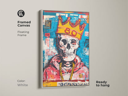 Framed canvas featuring a skull with a gold crown and gold chain. The canvas has a floating white frame. The modern art is ready to hang. This wall art is a great choice for your home decor.