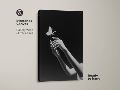 Stretched canvas print featuring a monochrome butterfly art. This minimalist black and white art is ready to hang. The gallery wrap and mirror edges give a contemporary look. This surreal hands canvas print will give any bedroom wall a modern touch. It's a unique wall decor gift for dreamers.