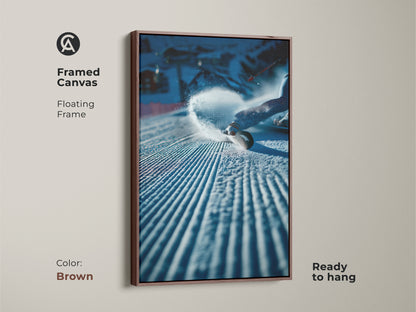 Framed canvas art print of a snowboarder in action. The floating frame is brown. It adds a touch of warmth to the piece. The artwork is ready to hang. It is ideal for creating a cozy yet dynamic atmosphere. Purchase now.