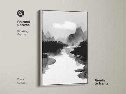 Framed canvas in white displaying a black white ink wash art print. The minimalist mountain river landscape canvas enhances minimalist office decor. The Japanese Sumi-e style artwork brings a calm aesthetic. This monochrome home decor is ideal for creating a peaceful environment.