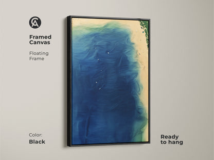 Framed canvas of abstract coastal art. The artwork features a black floating frame. Ready to hang deep blue wave artwork. Aqua green accents create a serene coastal vibe. Perfect for adding a touch of modern wall decor to your space.