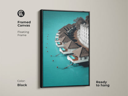 Black framed canvas of minimalist overwater bungalows. The floating frame enhances the turquoise ocean landscape. This contemporary resort wall art is ready to hang. Perfect for a chic resort living room or bedroom art.