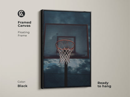 Framed canvas with a floating frame showcasing basketball art. Perfect gym wall art for athletes or man cave wall decor. This industrial-style basketball hoop artwork is ready to hang. The artwork has a black frame.
