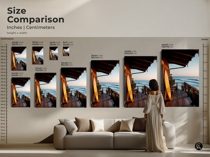 Compare sizes of coastal artwork showing a surfboard on a porch overlooking the ocean. View the artwork in inches and centimeters. See how different sizes fit in a room setting. This surf art is perfect for any space. Choose the ideal size for your home decor.