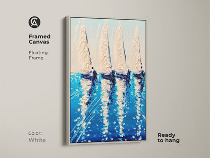 A white framed canvas displays deep blue sailboat artwork. This floating frame is ready to hang. The artwork brings the dynamic energy of the ocean to life. Coastal ocean wall art decor. A perfect housewarming gift adding maritime charm to any home.