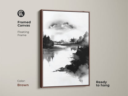 A framed canvas with a brown floating frame displaying minimalist forest lake art. The black and white nature print brings a touch of modern style. Ready to hang this ink wash landscape art is perfect for a calm bedroom artwork. A great housewarming gift.