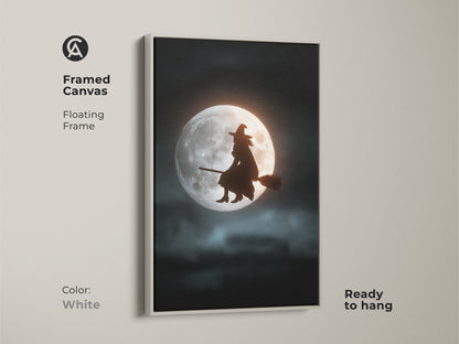 Framed canvas art showcasing a witch on a broom against a moonlit background. The white floating frame complements this Halloween night art print. Ready to hang dark fantasy wall decor. Ideal for lovers of celestial witch art.