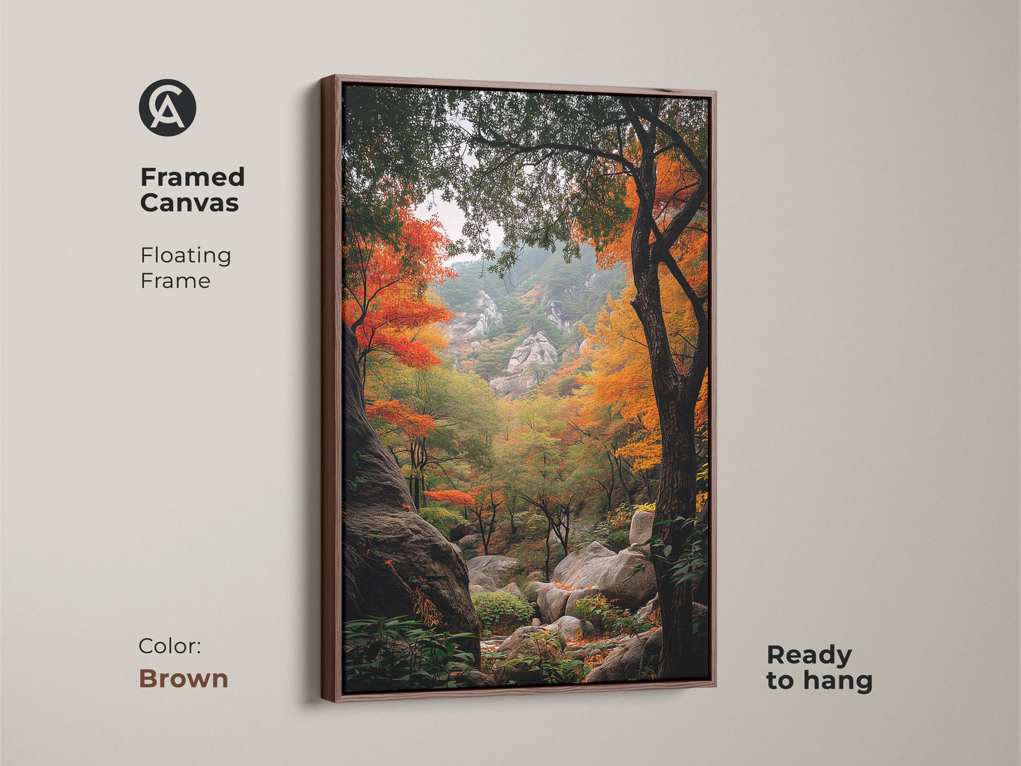 Brown framed canvas art displaying a serene autumn forest landscape. The floating frame adds a touch of elegance. This ready-to-hang artwork captures the essence of fall. The landscape art features colorful trees and rocky terrain. Perfect for home decor.
