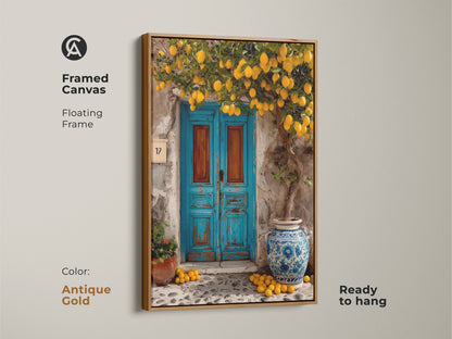 Framed canvas art with an antique gold floating frame showing a lemon tree and blue door. The ready-to-hang Mediterranean artwork adds a rustic and sunny touch. This boho wall decor is perfect for a kitchen or entryway. It is a travel-inspired gift.